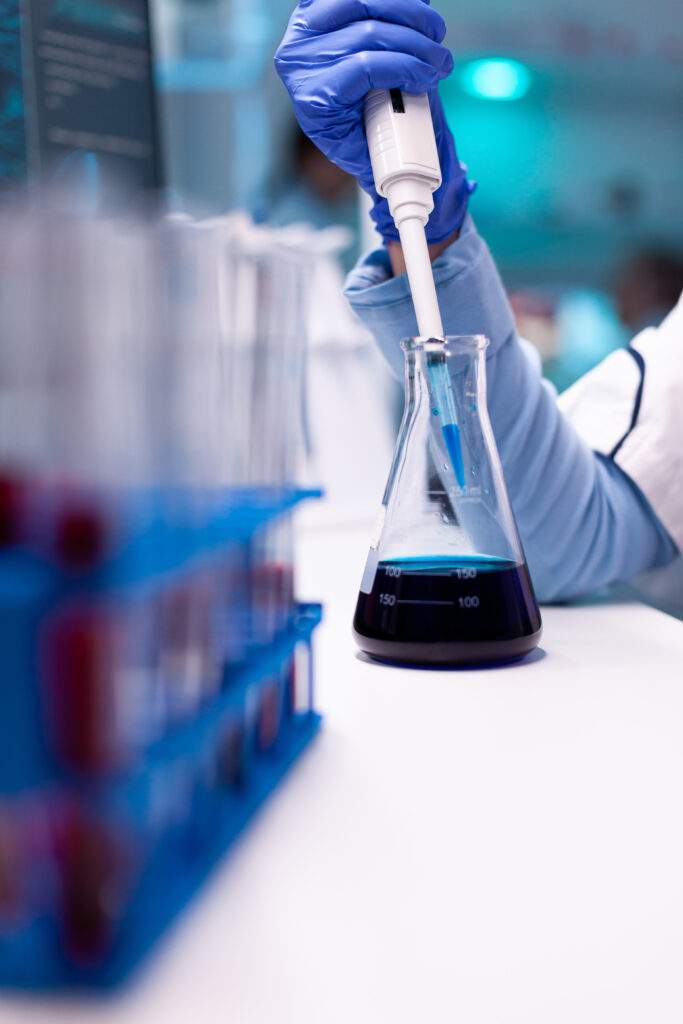 close up micropipette dipping test tube science experiment